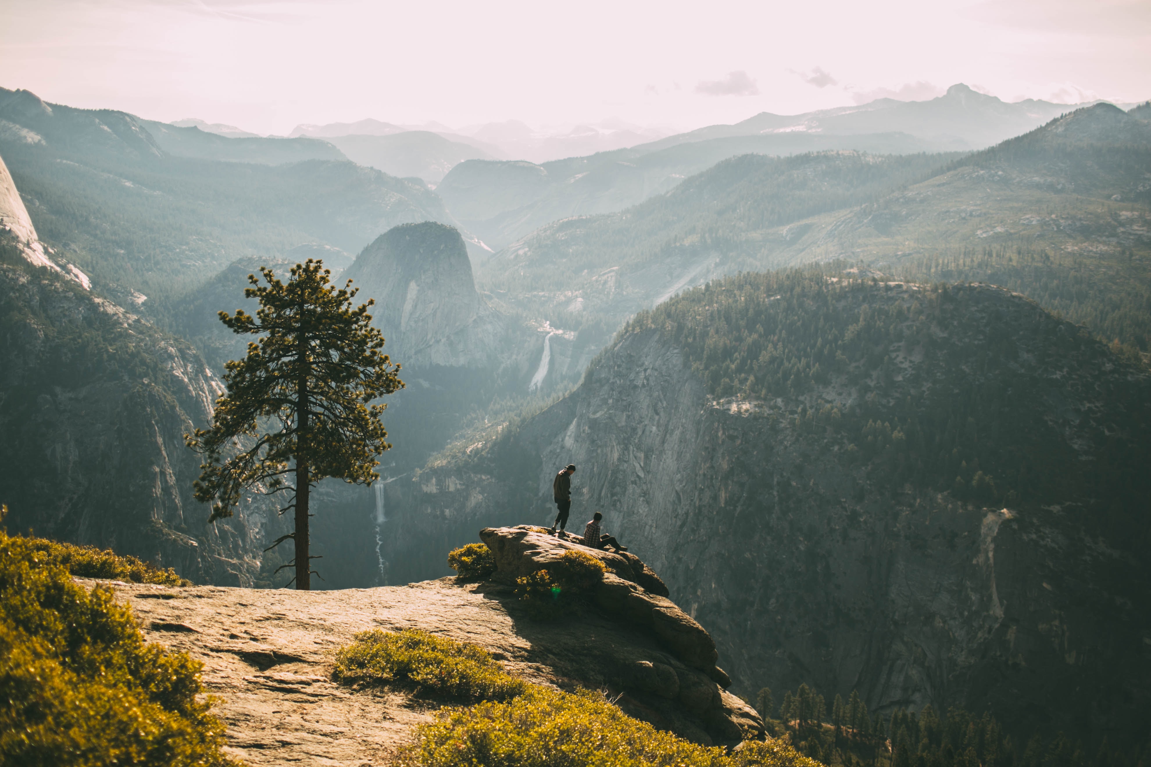 two people at the top of a mountain