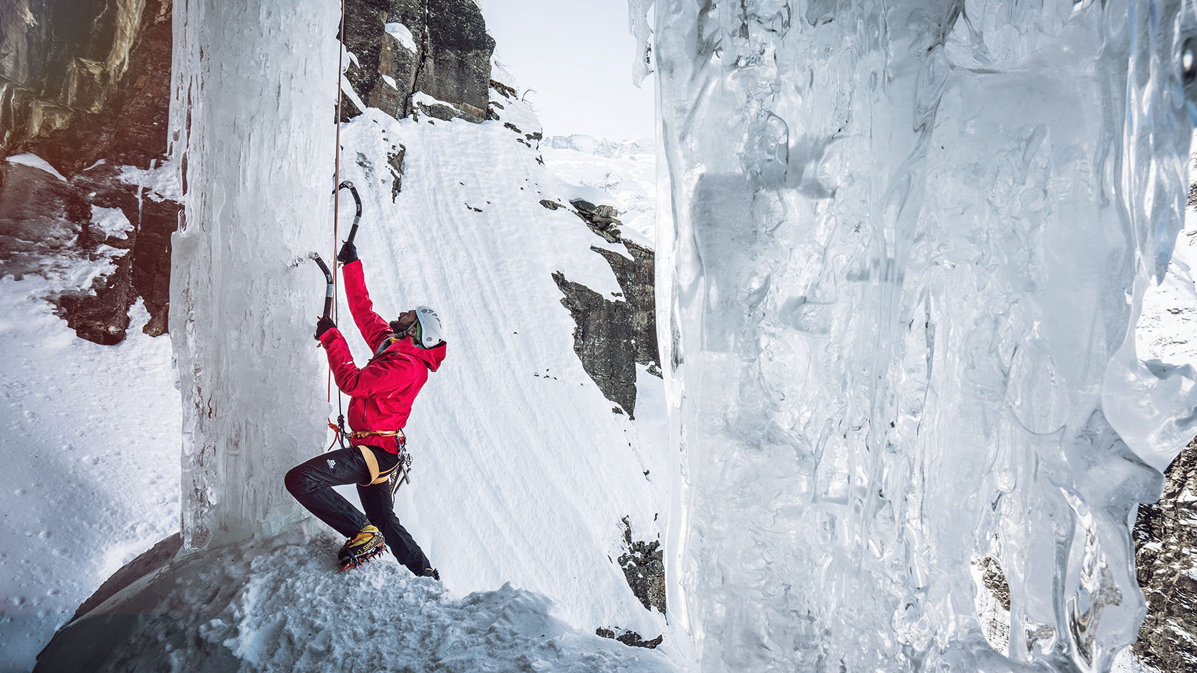 A person ice climbing in waterproof jacket 