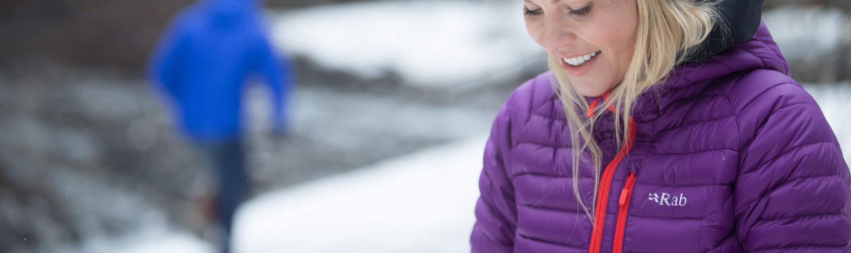 Down Insulation - Woman wearing a blue Rab jacket